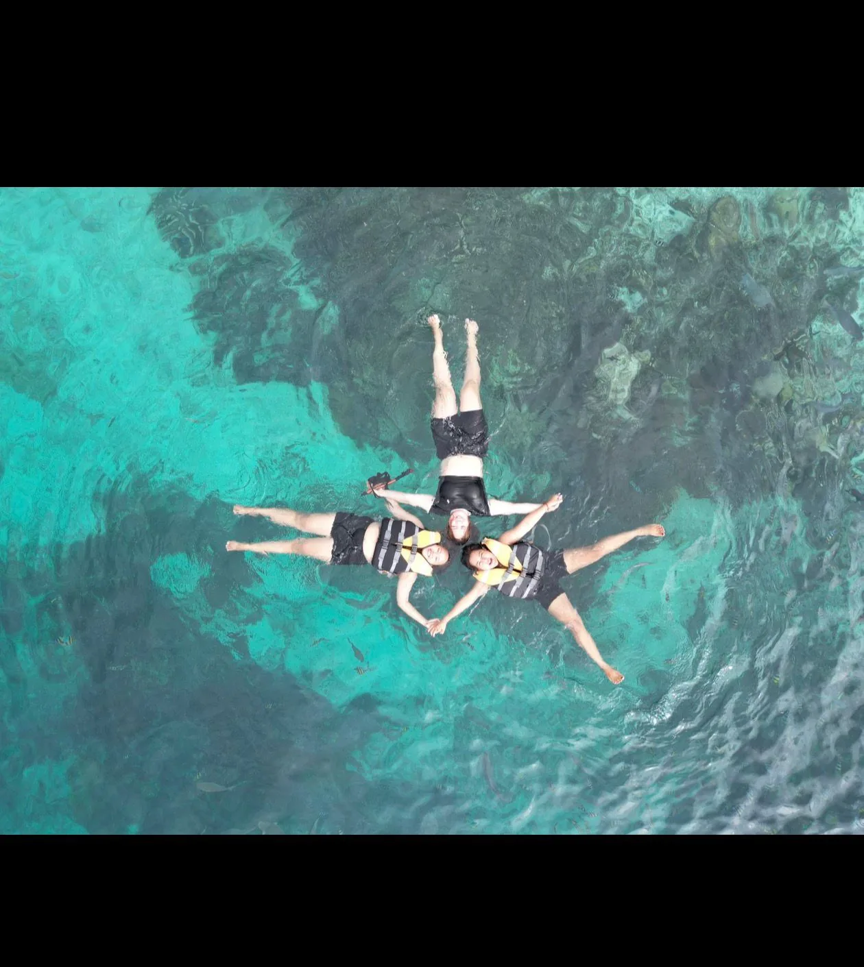Travelers floating in Raja Ampat water
